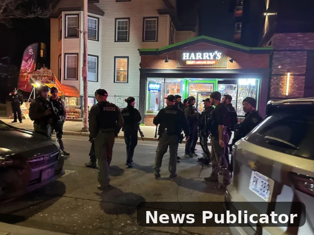 Police officers standing outside a restaurant near Brown University campus during a security operation after a shooting incident in Providence, Rhode Island.